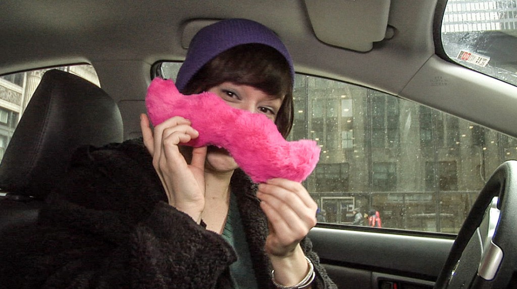 Kyle Lovett poses with the iconic pink mustache of Lyft ride-hailing service. (Ezra Kaplan/Medill)