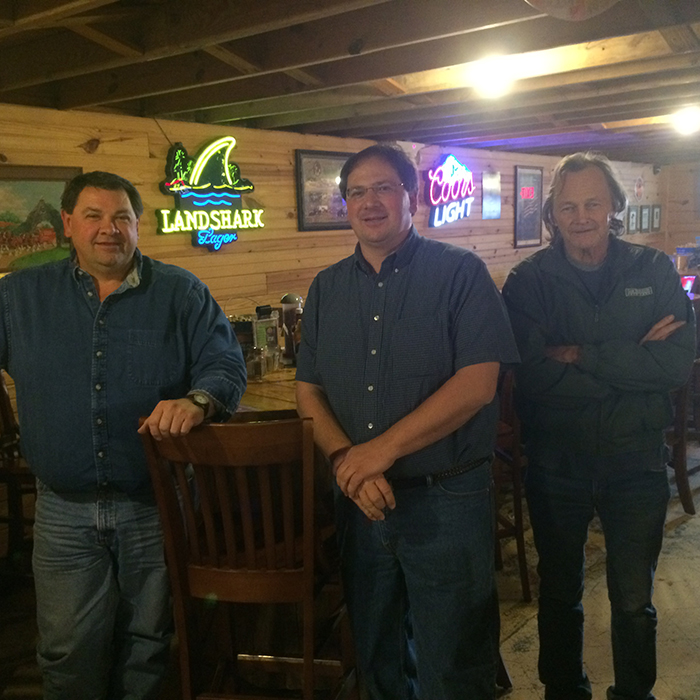 Anthony Booth (middle) saw marked decline in business at his restaurant after fracking companies lost interest in the area, where oil and business are interconnected. 