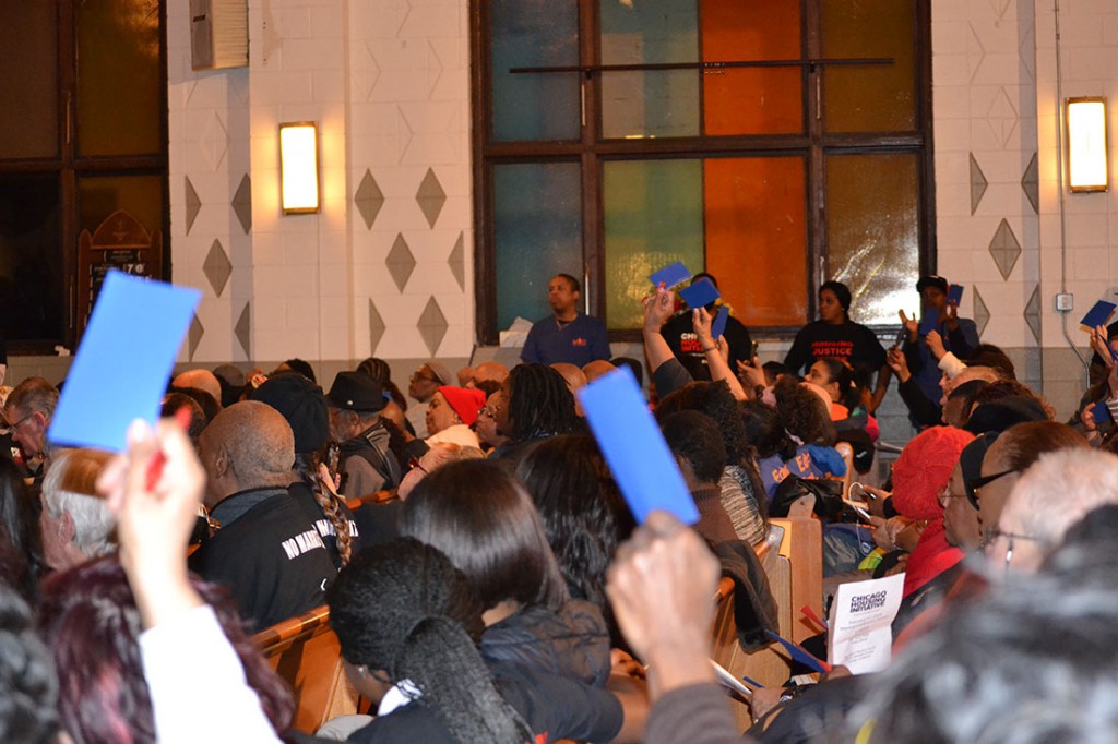 Members of the crowd wave blue cards to indicate their support for an answer from William "Dock" Walls. 