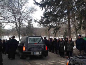 Hundreds of students, faculty and alumni, line the road from the Basilica to Fr. Ted's burial site at Holy Cross Cemetary. (Medill/Meghan Tribe)
