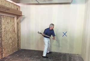 John Guida takes the first swing to what will be the new artistic wing at the Hyde Park Art Center.  The wing will create 5,000 square feet of artist workspace. (Traci Badalucco, Medill)