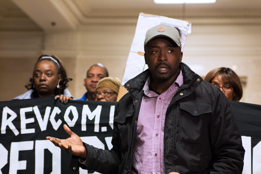 Mark Carter, an organizer with One Chicago, leads protesters in a demonstration outside the Mayor's office at City Hall Wednesday afternoon. (Raquel Zaldivar/Medill