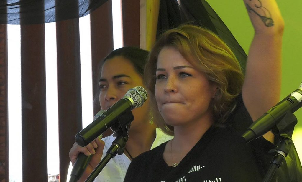 Shena Gutierrez calls for an end to border militarization at a rally on the U.S.-Mexico border in Nogales, Arizona