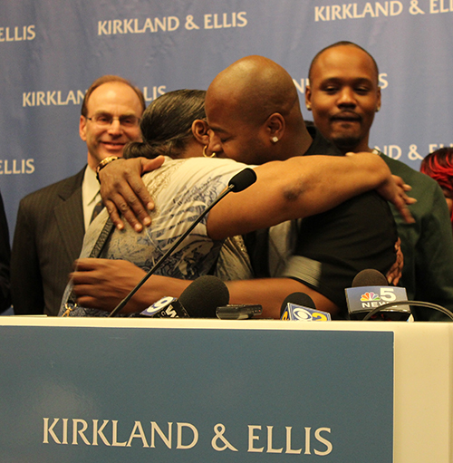 Theresa Johnson embraces her son, Charles, at Wednesday's press conference to discuss Johnson and three other men's exoneration. (Kara Voght/MEDILL)