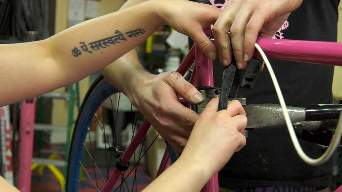 People repair a bike together