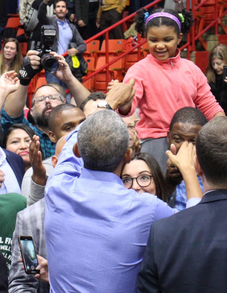 Obama shaking hands with young girl