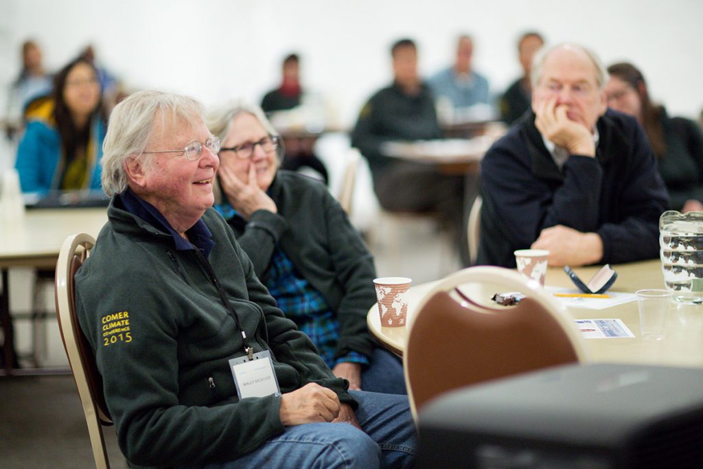 Wally Broecker, left, sits with his wife Elizabeth, center, while listening to a research presentation at the 2015 Comer Climate Conference. (Jasmin Shah/Comer Family Foundation)